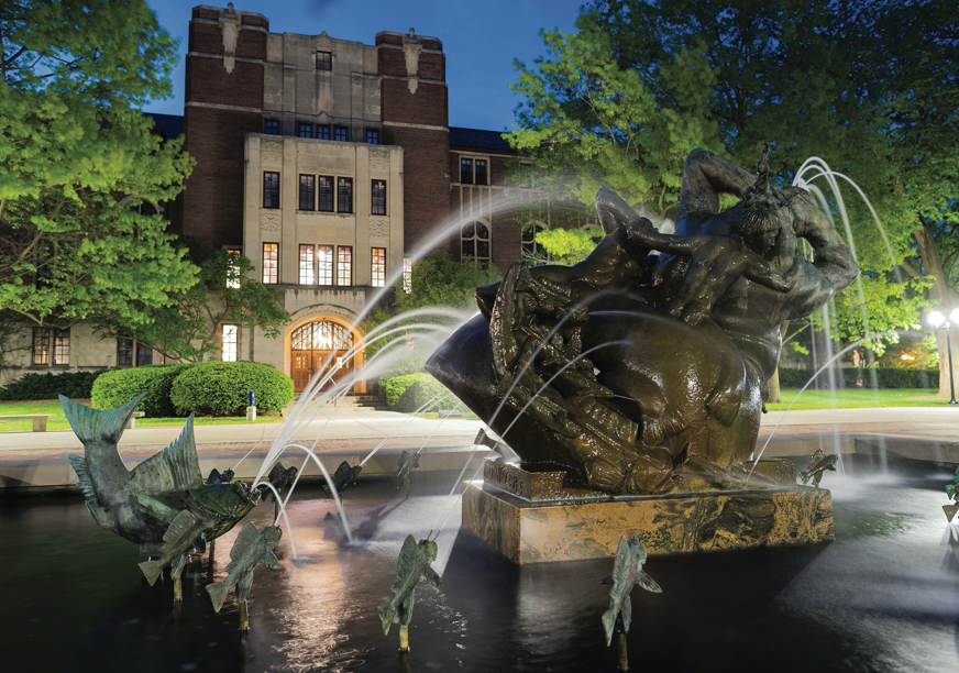 The fountain on Ingalls Mall in the spring, with the University League in the background.