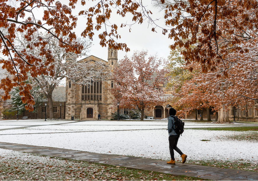 A student crosses U-M's famous Law Quad on a winter day.