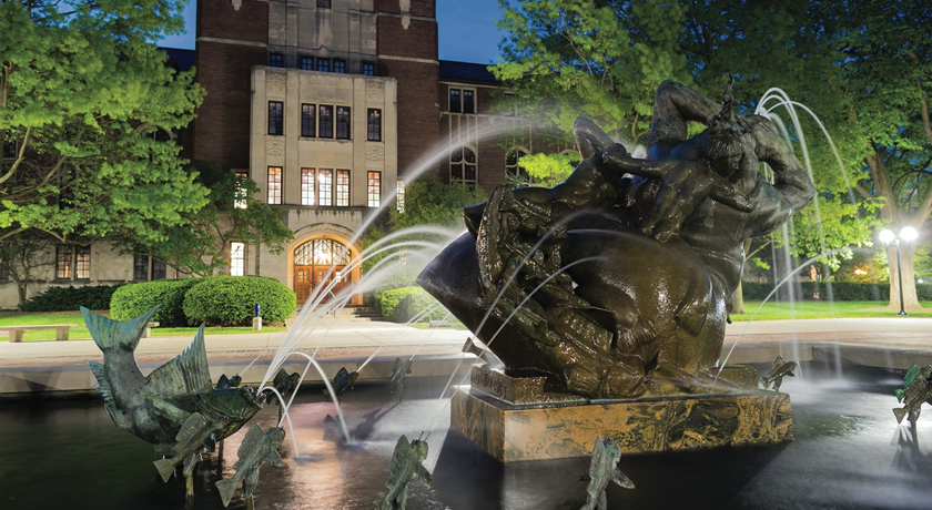 The fountain on Ingalls Mall in the spring, with the University League in the background.